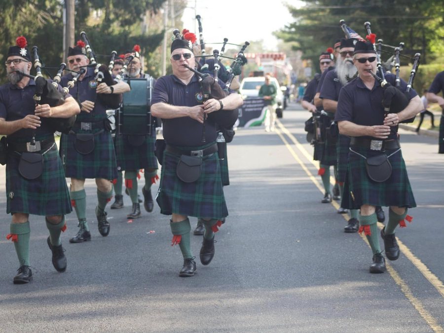 Pipers and drummers marching down a parade route